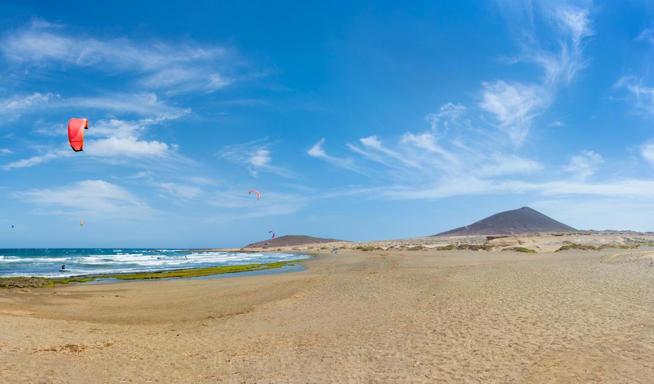 Kitesurfer kites flown over the sea at Playa de El Médano