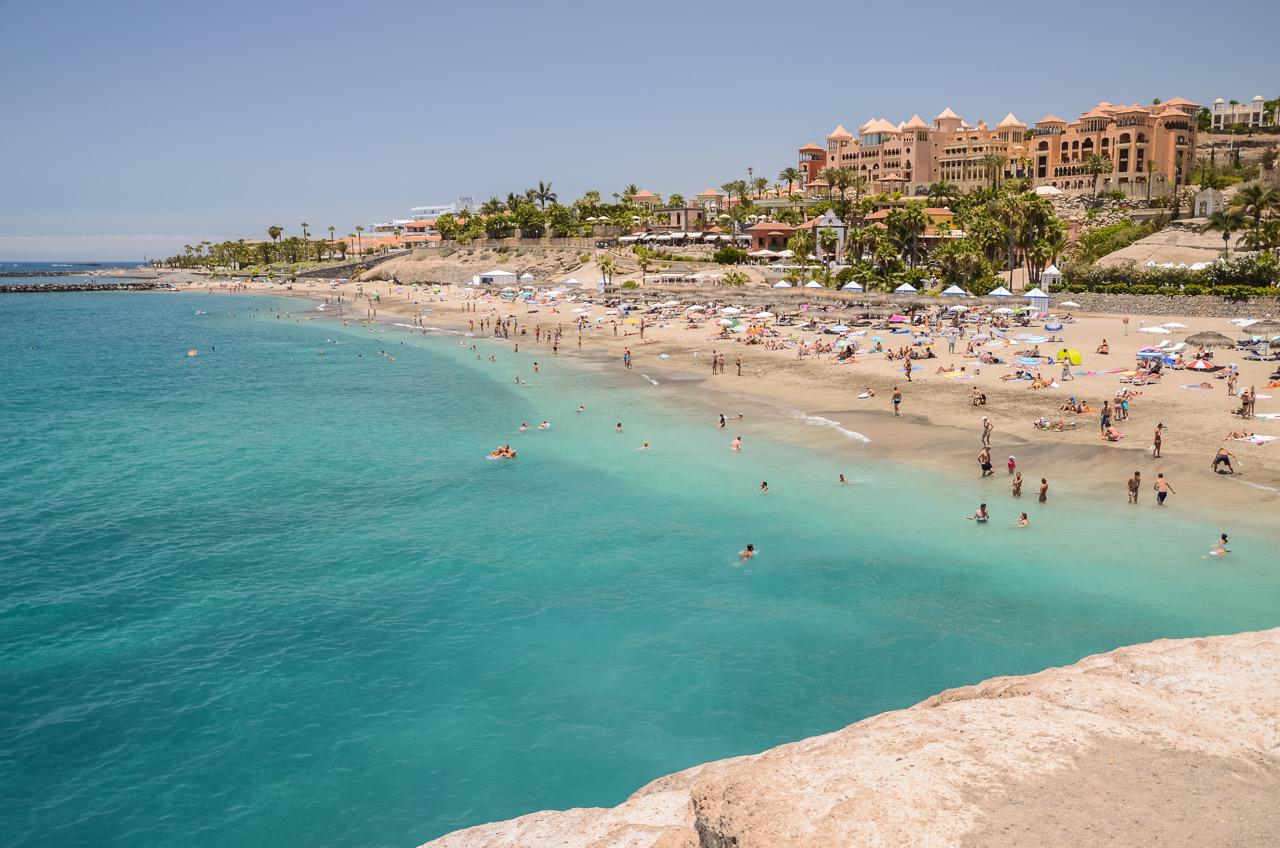 People swimming and sun-bathing at Playa del Duque Tenerife