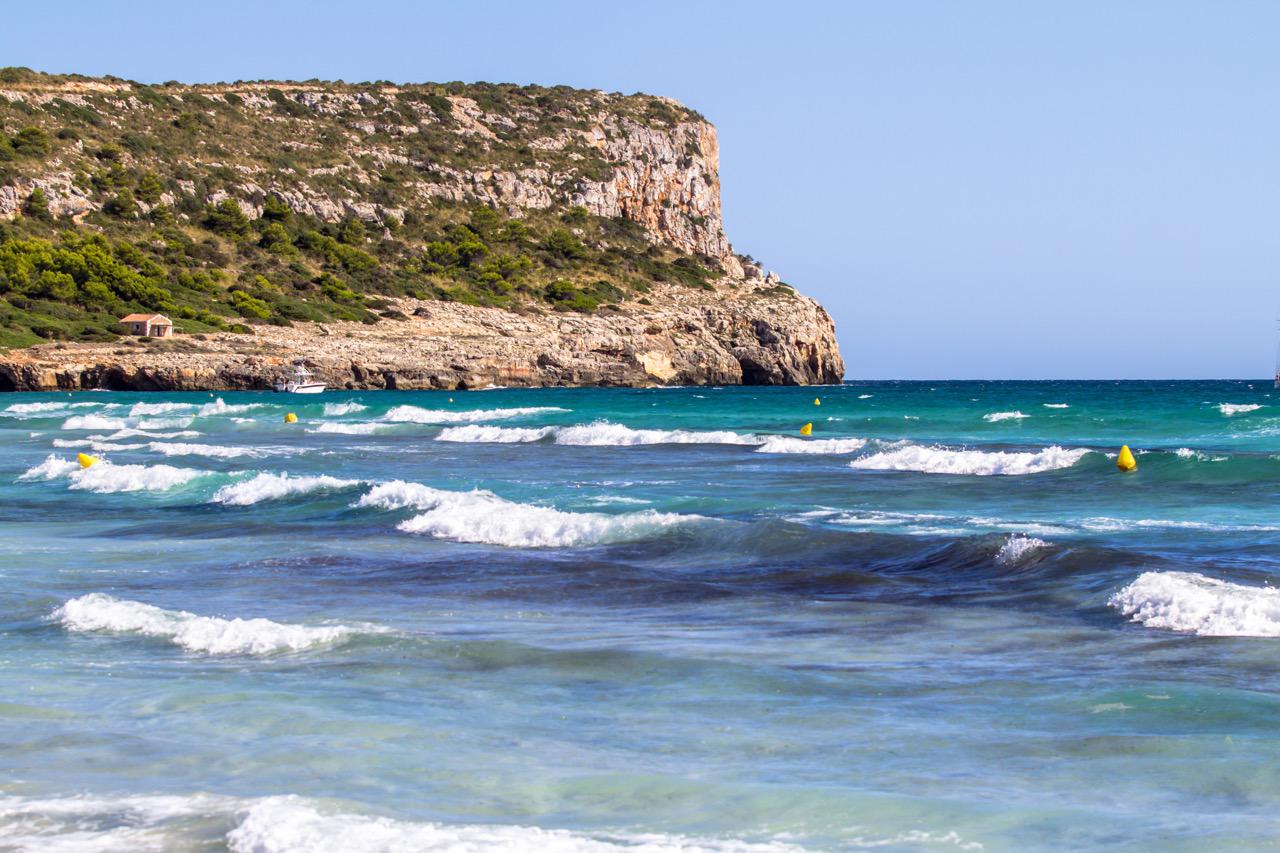 Calm waves along the Son Bou beach coast