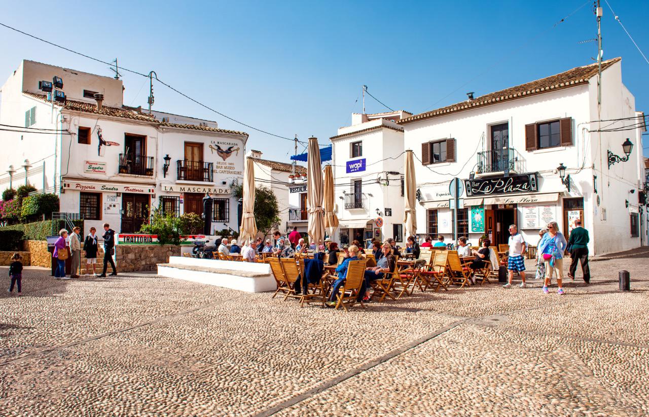 Small square in the town of Altea filled with people on terraces