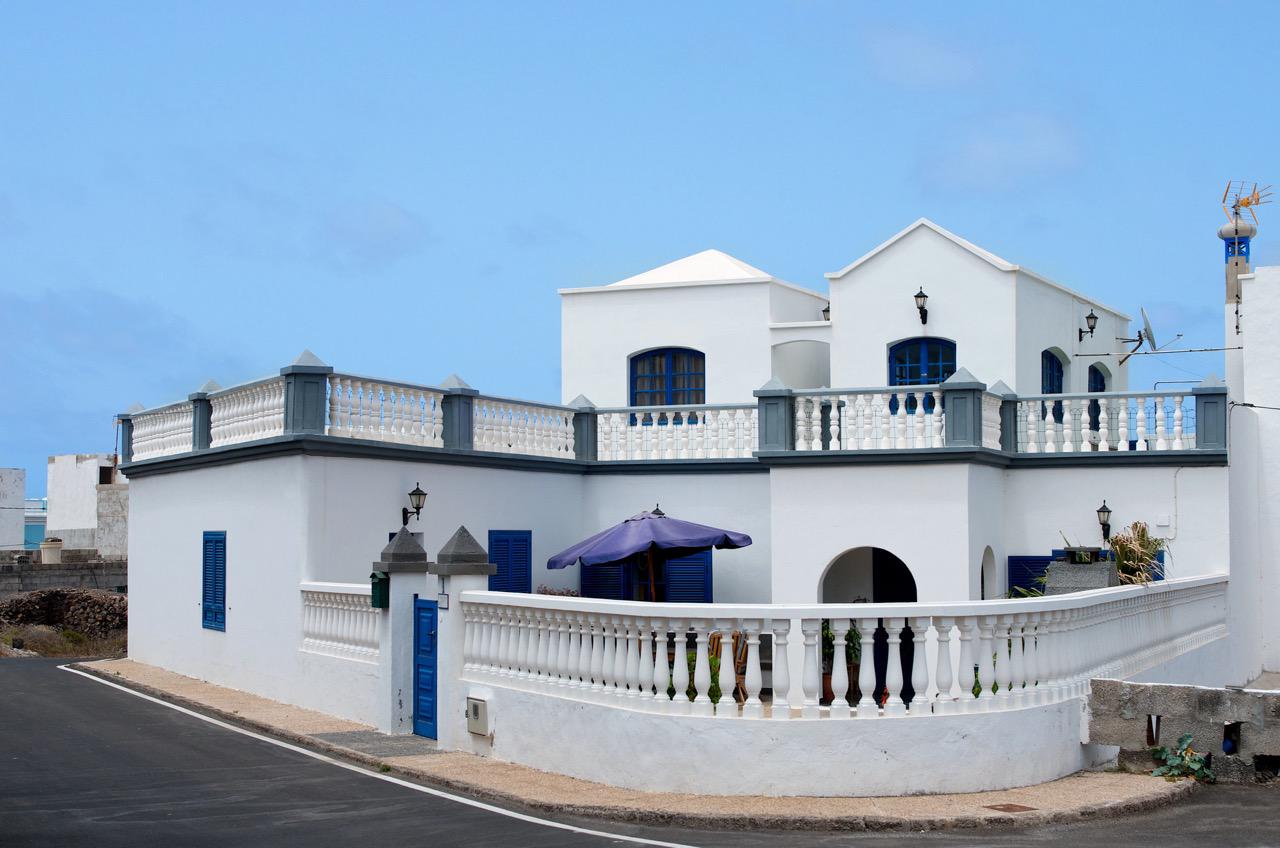 Typical white washed villas with blue or green doors and shutters